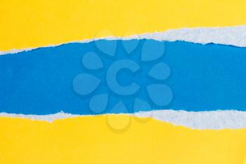 Torn yellow paper with a blue background for your text.