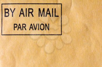 Black air mail stamp on yellow envelope