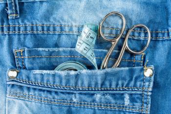 Close up of jeans pocket with fashion designer tools