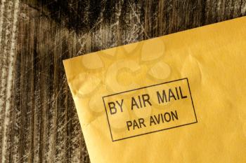 Yellow envelope with black air mail stamp 