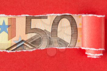 Fifty Euro bill in torn red paper frame