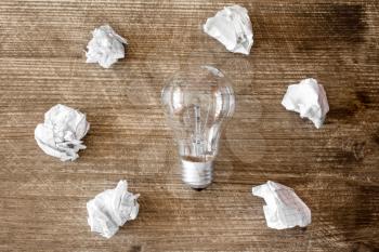 New idea concept with lightbulb and crumpled office paper