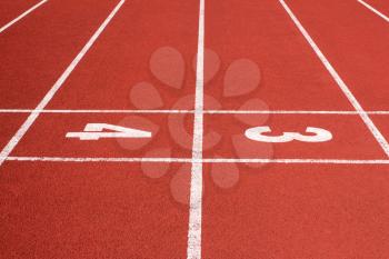 Running track with the numbers three and four