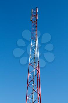 Communication antenna tower on the blue sky background