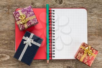 Personal organizer and gift boxes on the wooden background