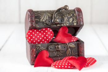Open wooden box with a cute little hearts inside. 
