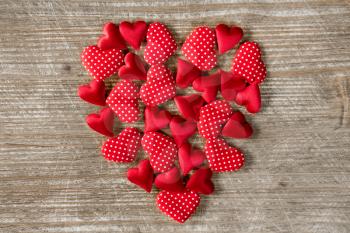 Heart shape formed with small hearts on wooden background. Love concept. Valentine's Day concept.