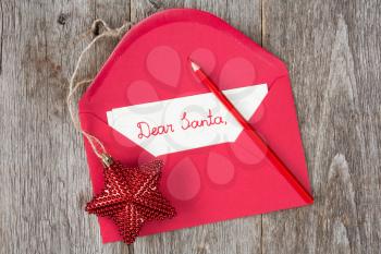 Christmas star and envelope with child's letter to Santa 