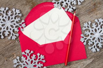 Blank letter with red pencil and silver snowflakes 