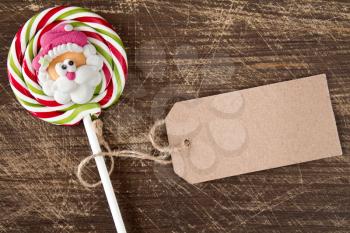 Face of Santa on Christmas lollipop with blank price tag 