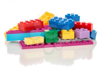 Toys background with colorful plastic building blocks isolated on white
