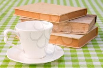 Cup of coffee with books on the table.