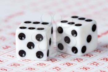 Close-up of dices on lottery ticket, concept for gambling