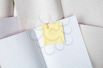 Blank exercise books with yellow sticky note,copy-space