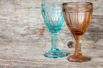 Two empty crystal wineglasses on a wooden background