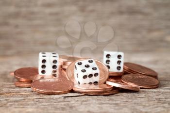 Close up of coins and dices on wooden background