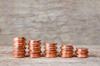 Five stacks of copper coins  increase in height 