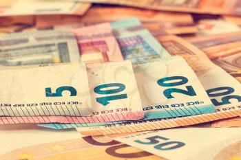 Close-up of various Euro banknotes, filtered image.