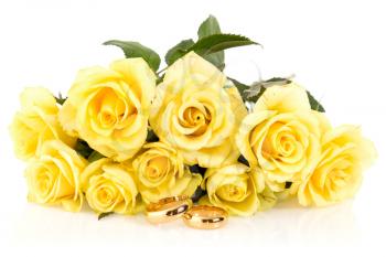 Wedding rings with bunch of roses isolated on white background