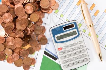 Financial analyzing concept, calculator,pen and  Euro cents on paperwork