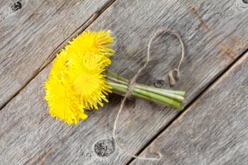 Bunch of yellow dandelion flowers tied with rope.Top view.