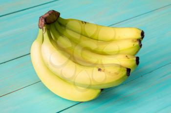 Bunch of bananas on blue painted wooden background