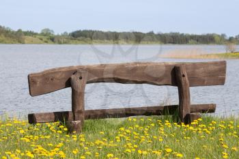 Empty wooden bench at the lake shore,ideal place for resting
