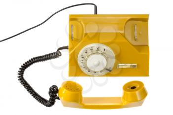 Yellow rotary phone isolated on white background. Top view.