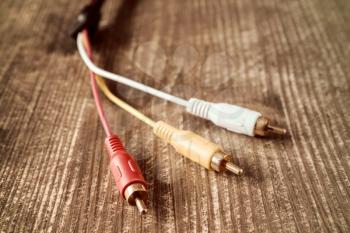 Audio-video analog cable,close-up on wooden background