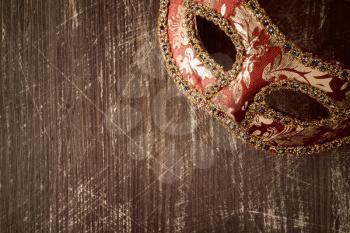 Carnival Venetian mask on the dark wooden background