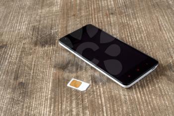 Smartphone and SIM card on the table