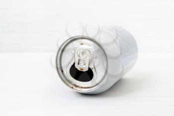 Empty can of soda on the wooden background