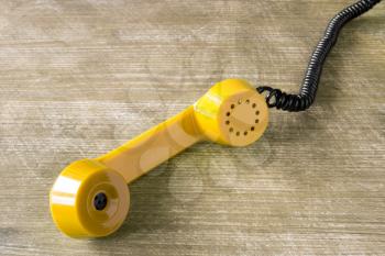 Yellow receiver of old vintage classic telephone