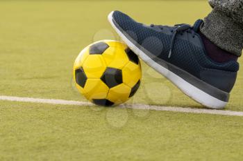  Foot of player with ball on artificial turf soccer field