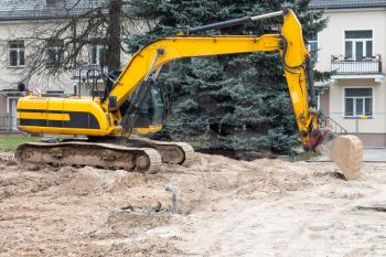Excavator machine in construction site