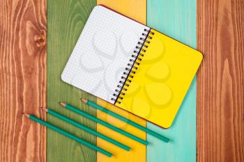 Personal organizer and four pencil on color background.Copy-space for your text.