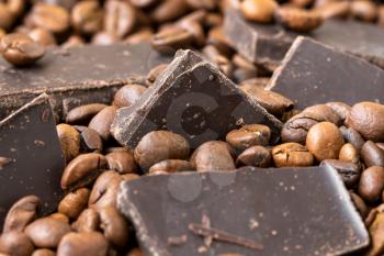 Chocolate pieces in fresh roasted coffee beans
