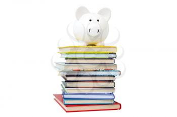Piggy bank on a stack of books, isolated on white background