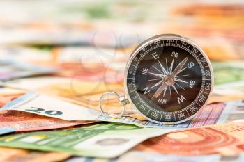 Magnetic compass on euro banknotes. Europe economy direction, financial or investment  concept