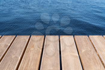 Wooden Dock or Pier in a lake from the POV from the shore 