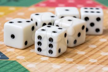 Six white dice on board game background