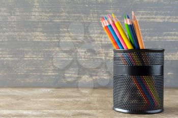Colorful pencils in the metal pen pot