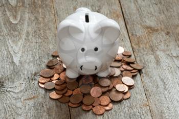 Piggy Bank on top of coins. Money concept. Saving for vacation. Home Finance concept