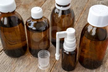 Brown glass medical bottles on the wooden background