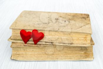 Old books and two red hearts. Book love concept.Valentine's day concept.