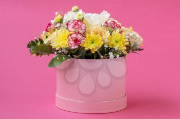Flower arrangement in a hat box , a pot of pink for a girl on a gift
