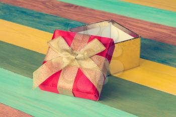 Open gift box on color wooden background.Copy-space.