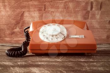 Old vintage classic telephone on wooden table