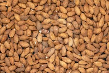Organic almond nuts as background, top view. Healthy snack