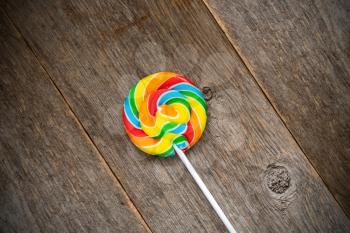 Fruity colorful lollipop on old wooden background